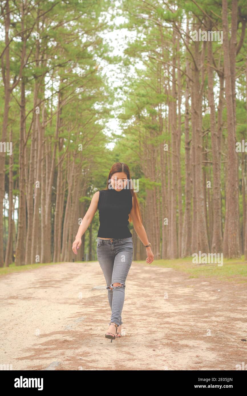 Asian calm woman alone walking hi-res stock photography and images - Alamy