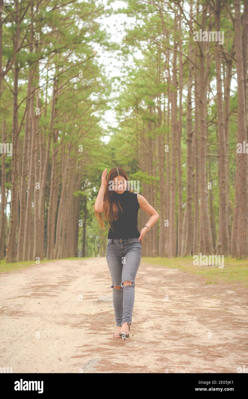 Asian calm woman alone walking hi-res stock photography and images - Alamy