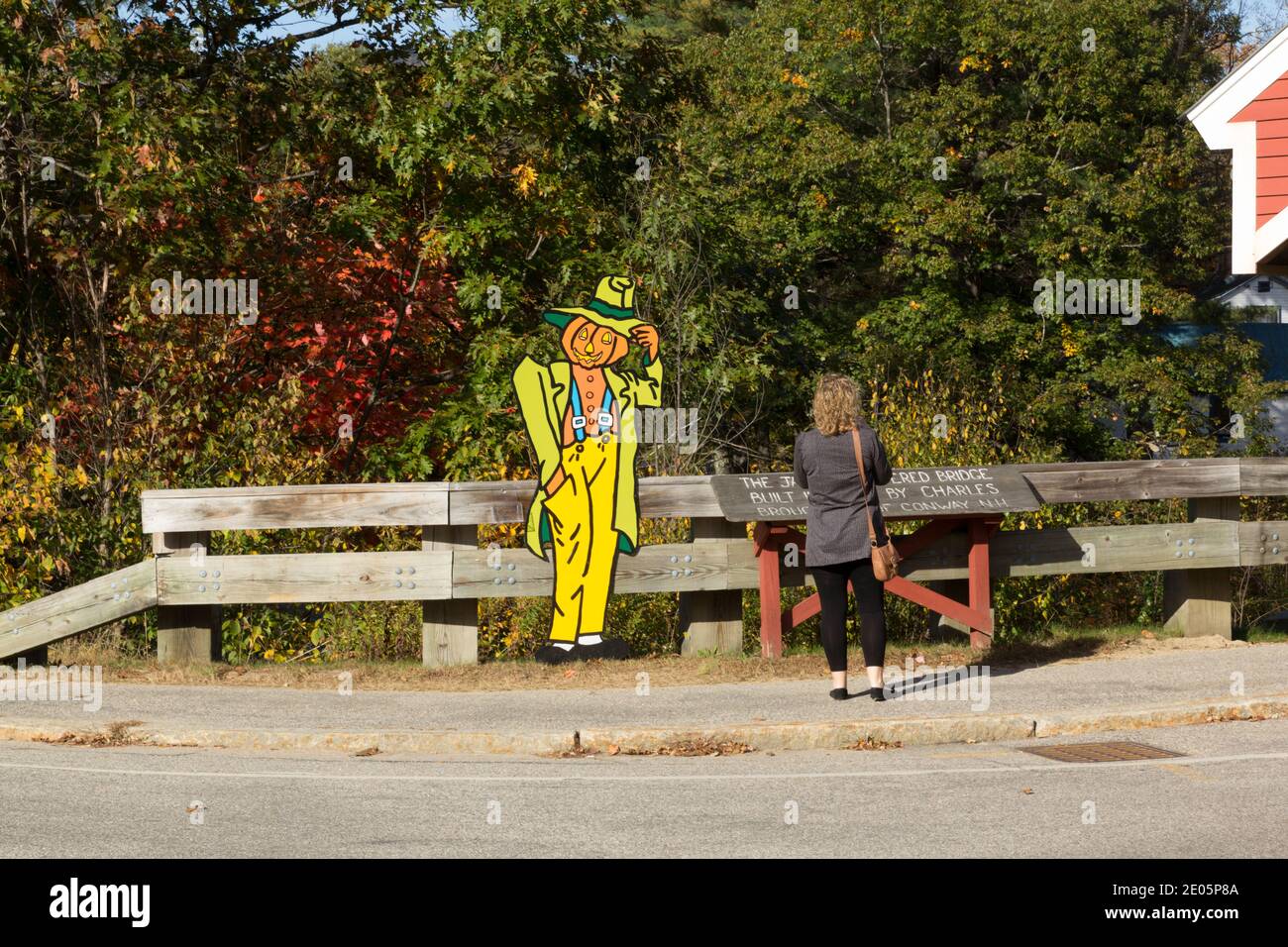 Pumpkin man tipping he's hat to a lady Stock Photo