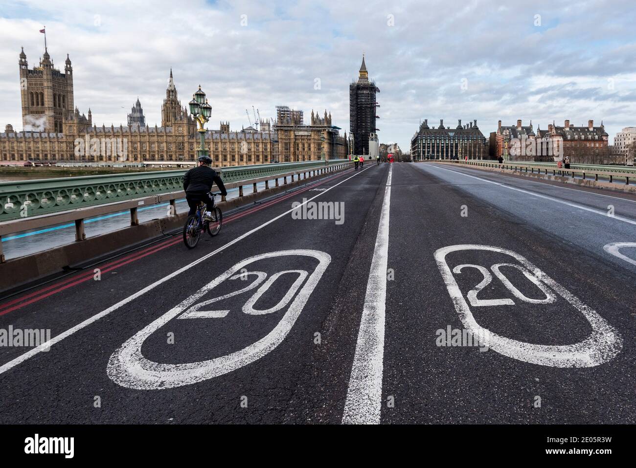 London, UK.  30 December 2020. The Houses of Parliament stand behind a pair of 20 miles per hour speed limit signs on the road on Westminster Bridge which, together, show the year 2020.  As 2020 draws to a close, MPs are due to ratify the UK/EU trade deal in Parliament today.  At the same time, the UK government is trying to tackle the effects of the record levels of coronavirus cases which may require an increase in national tier alert levels.  Credit: Stephen Chung / Alamy Live News Stock Photo