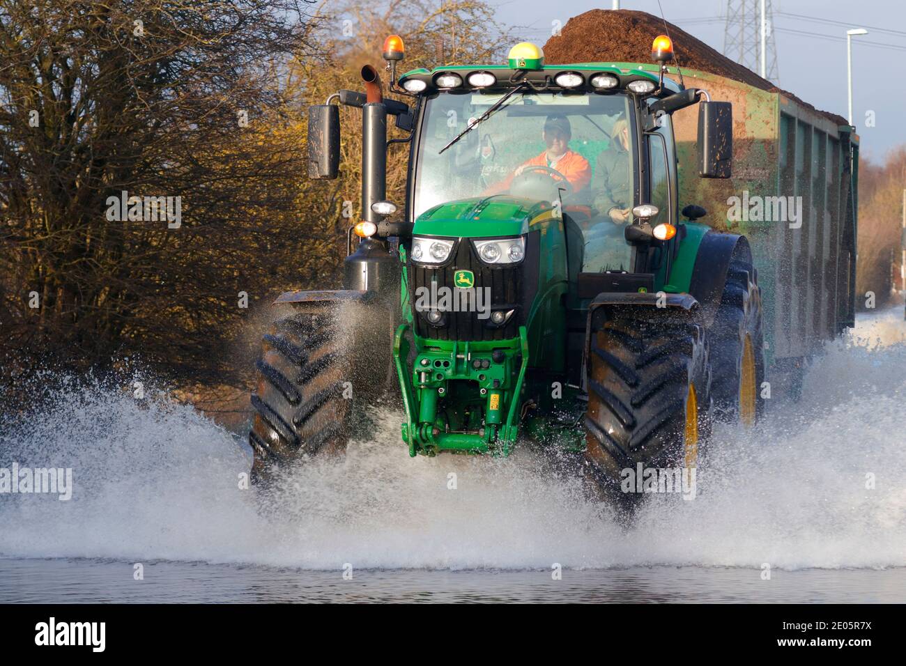 A tractor driving through Storm Bella floods on Barnsdale Road in