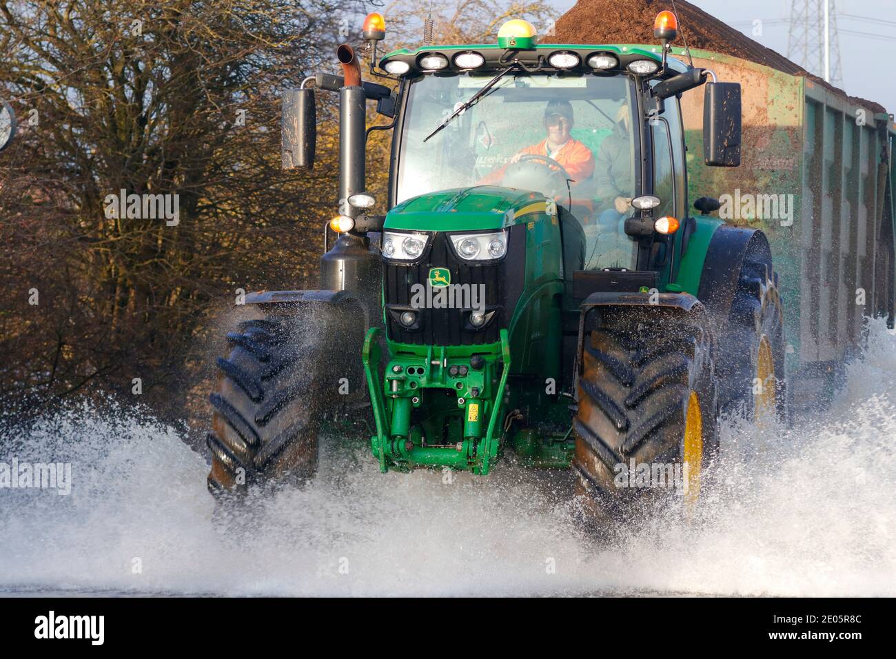 A tractor driving through Storm Bella floods on Barnsdale Road in