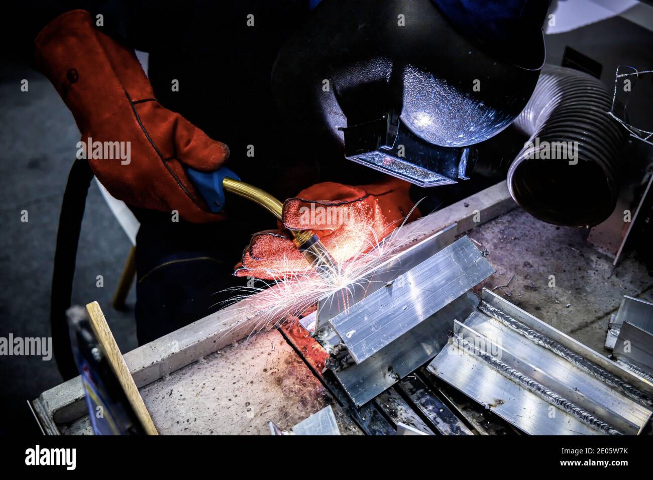 Welding steel with spread spark and lighting around. Stock Photo