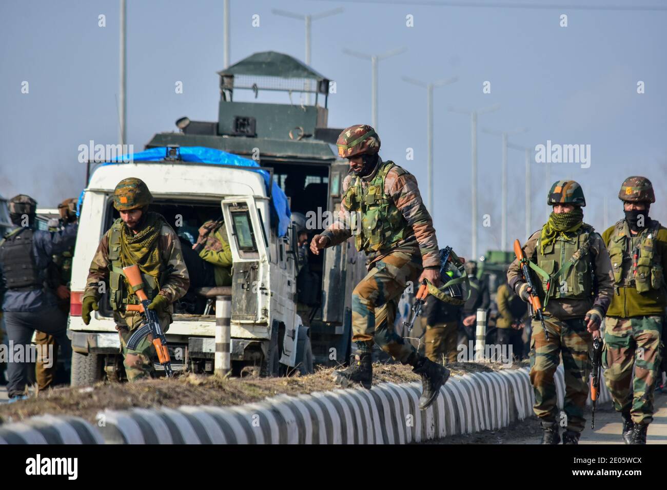 Indian army soldiers walk towards the gun battle site on the outskirts of Srinagar. Three militants were killed in an overnight gun battle with government forces in Lawaypora area of Srinagar. The militants killed were planning a big strike on the Srinagar-Muzaffarabad highway, an official said. Stock Photo