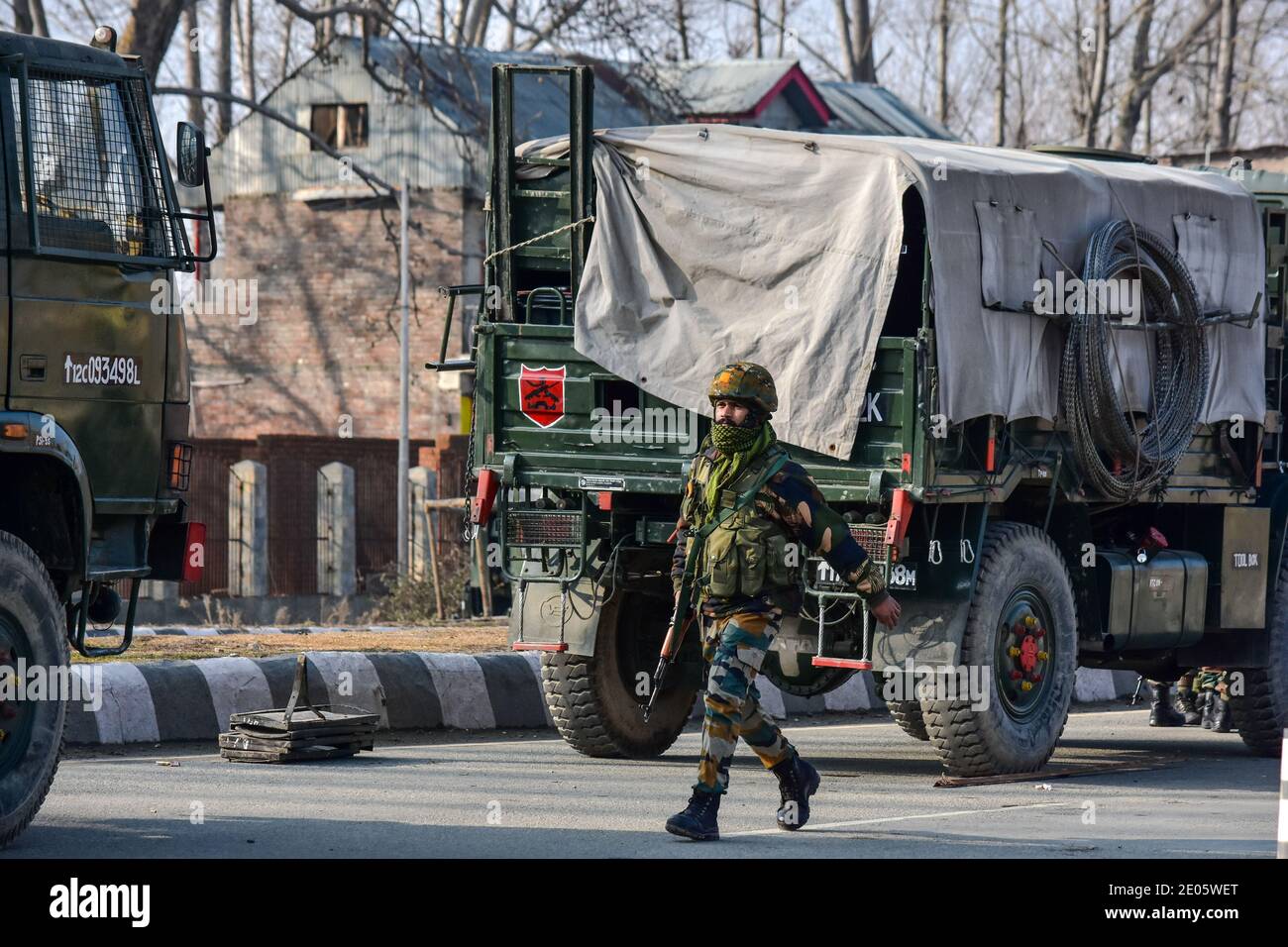 An Indian army soldier patrols near the gun battle site on the outskirts of Srinagar. Three militants were killed in an overnight gun battle with government forces in Lawaypora area of Srinagar. The militants killed were planning a big strike on the Srinagar-Muzaffarabad highway, an official said. Stock Photo