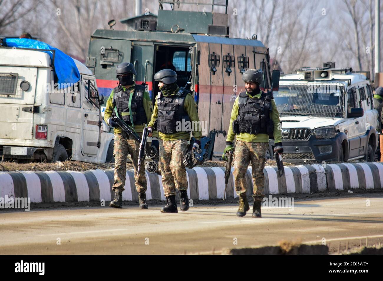 Indian army soldiers patrol near the gun battle site on the outskirts of Srinagar.Three militants were killed in an overnight gun battle with government forces in Lawaypora area of Srinagar. The militants killed were planning a big strike on the Srinagar-Muzaffarabad highway, an official said. Stock Photo