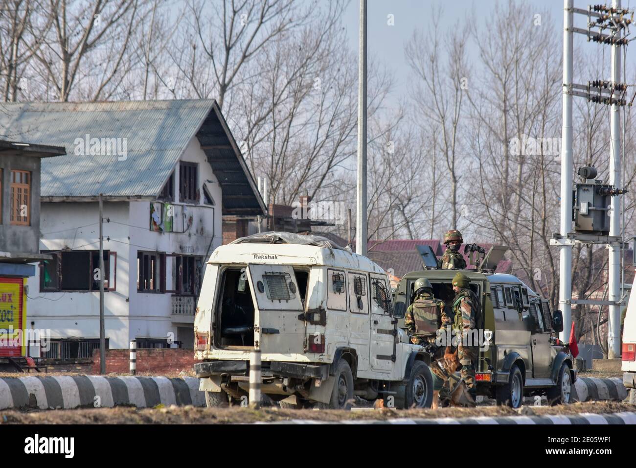 Indian army soldiers take position near the gun battle site on the outskirts of Srinagar.Three militants were killed in an overnight gun battle with government forces in Lawaypora area of Srinagar. The militants killed were planning a big strike on the Srinagar-Muzaffarabad highway, an official said. Stock Photo