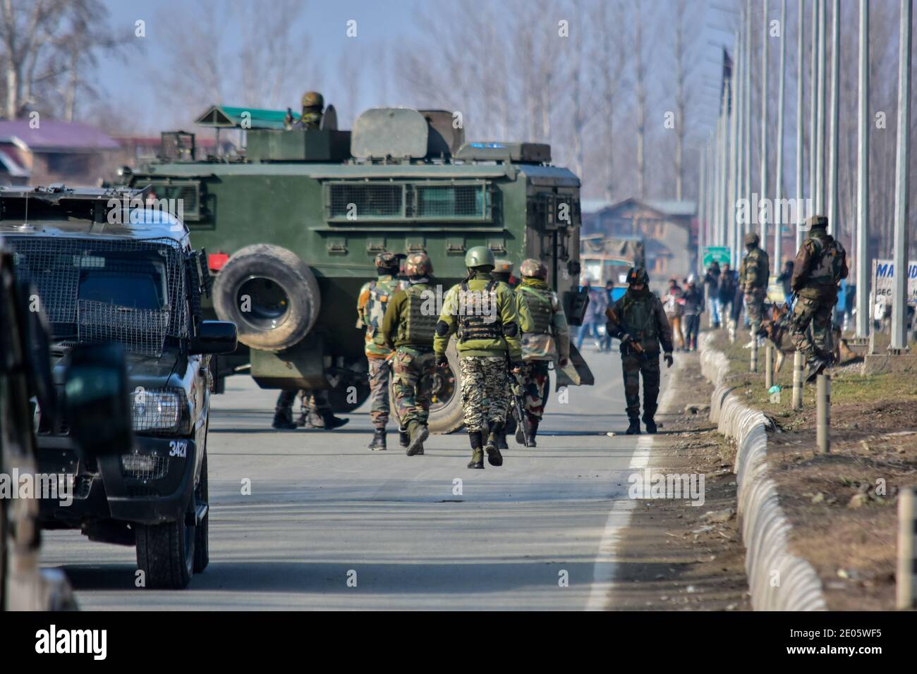 Indian army soldiers patrol near the gun battle site on the outskirts of Srinagar.Three militants were killed in an overnight gun battle with government forces in Lawaypora area of Srinagar. The militants killed were planning a big strike on the Srinagar-Muzaffarabad highway, an official said. Stock Photo