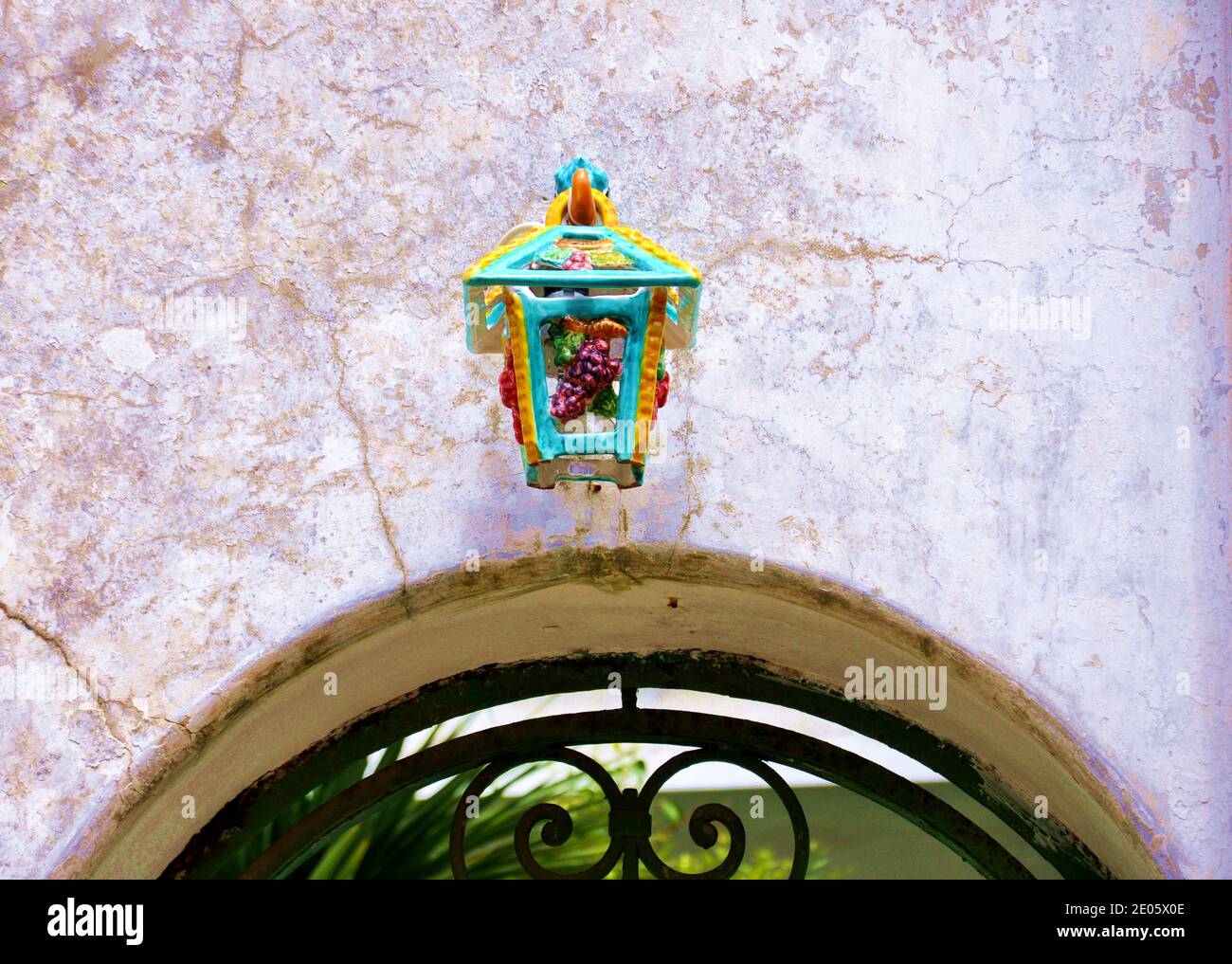 Colored ceramic streetlamp above a garden door, minimalist style Stock Photo