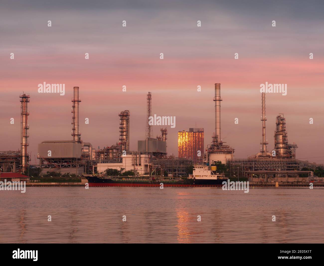 View of the oil refinery by the river in the sunset Stock Photo - Alamy