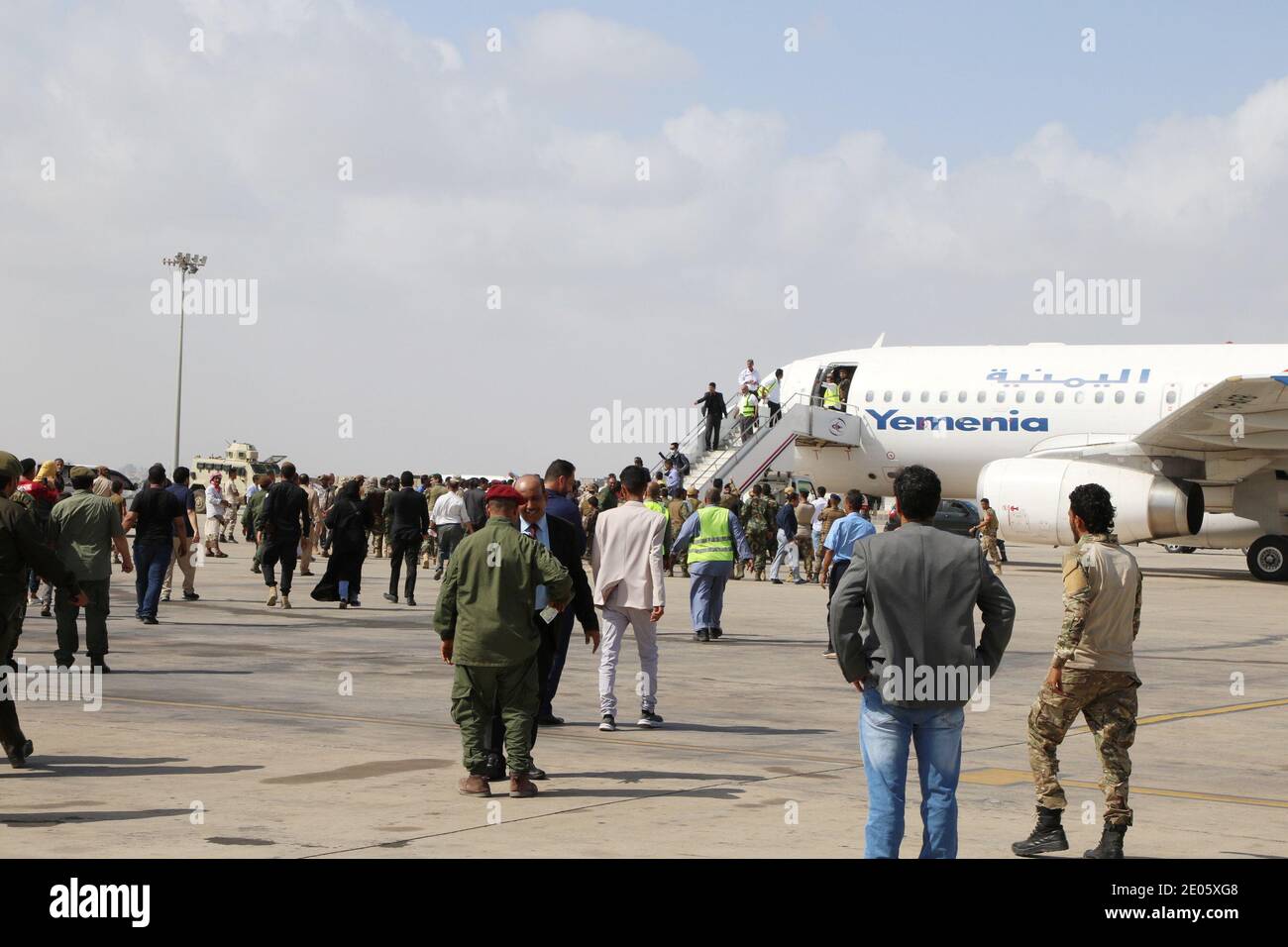 People wait to greet members a newly formed cabinet for government-held  parts of Yemen upon their arrival at Aden airport, before an attack on the  airport, in Aden, Yemen December 30, 2020.