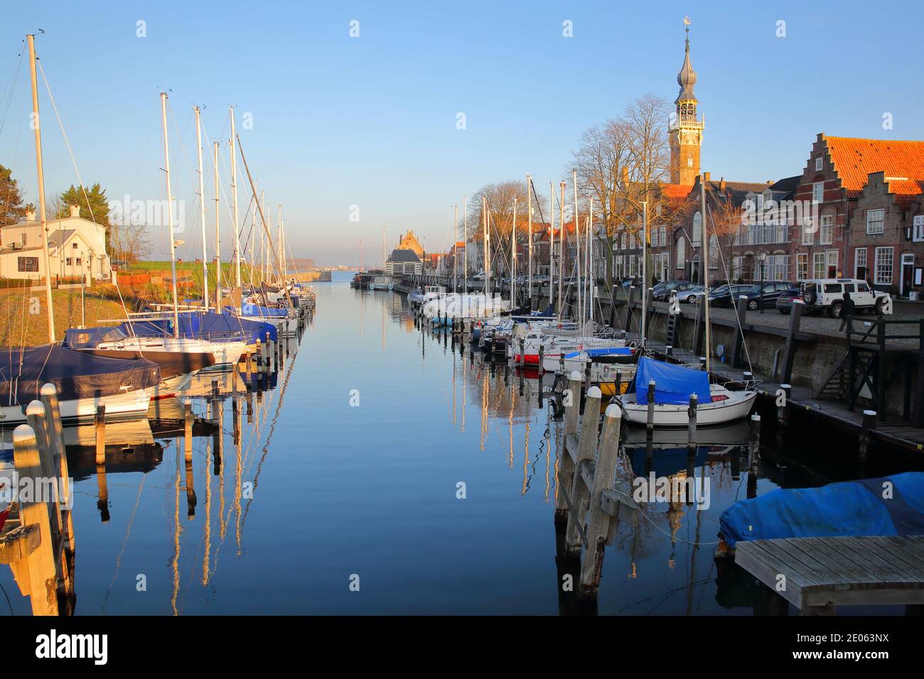 VEERE, NETHERLANDS - DECEMBER 10, 2020: The marina (harbor) and historic buildings with the clock tower of the Stadhuis (town hall) Stock Photo