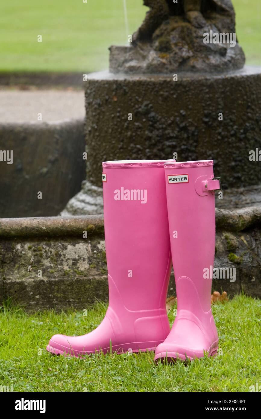 Pair of ladies pink wellington boots on grass Stock Photo