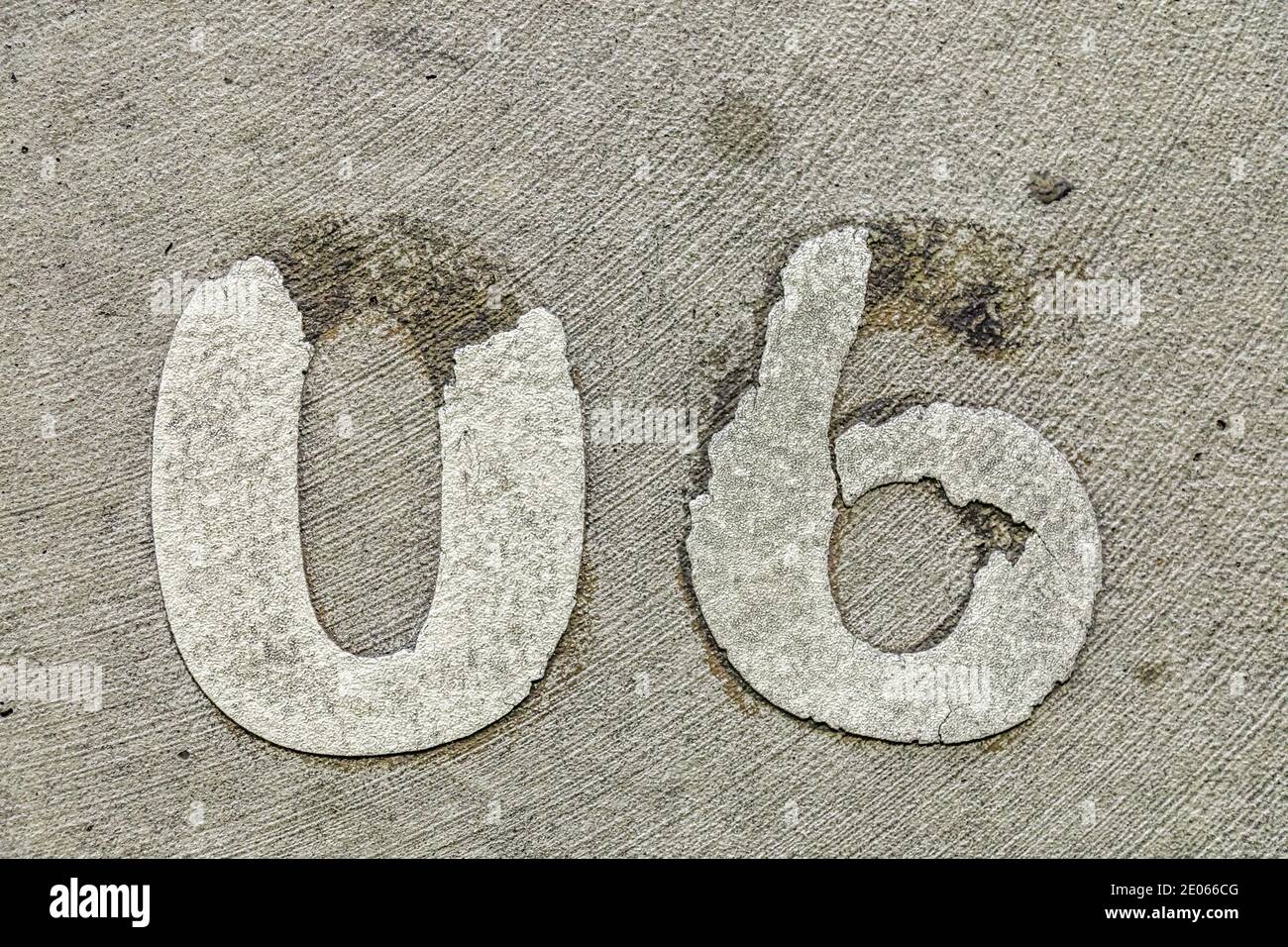 The numbers 06 applied to a concrete floor and in bad shape Stock Photo