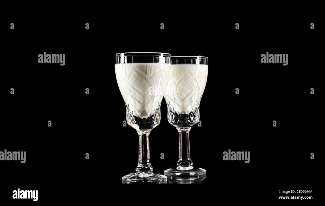 Crystal shot glass with milk on black background.Anti-alcohol concept.Drink milk-be healthy Stock Photo