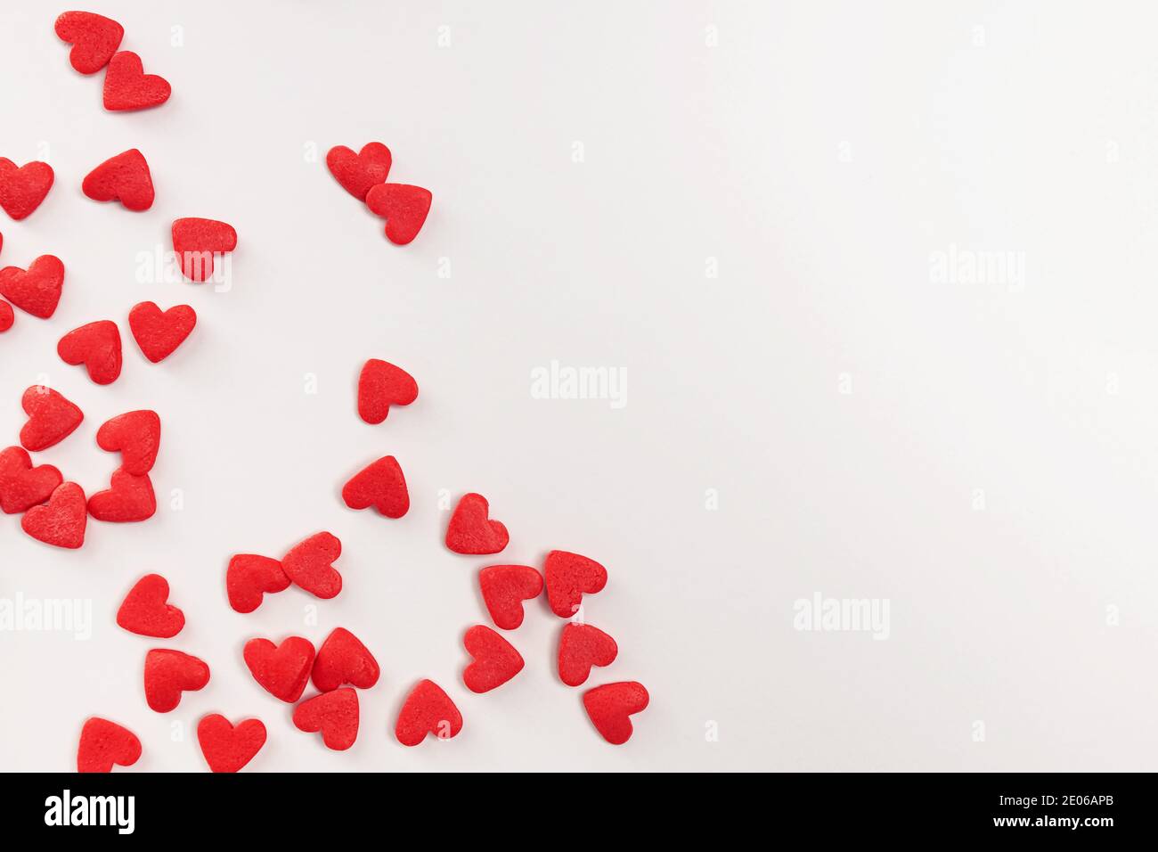 Sugar heart shaped sprinkles on white background Stock Photo