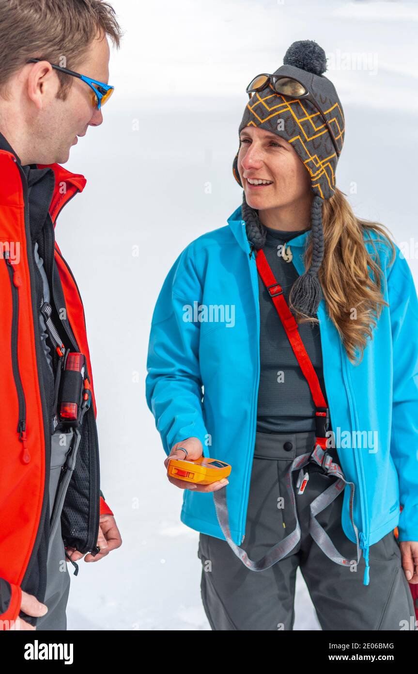 Alpinists checking avalanche safety equipment Stock Photo