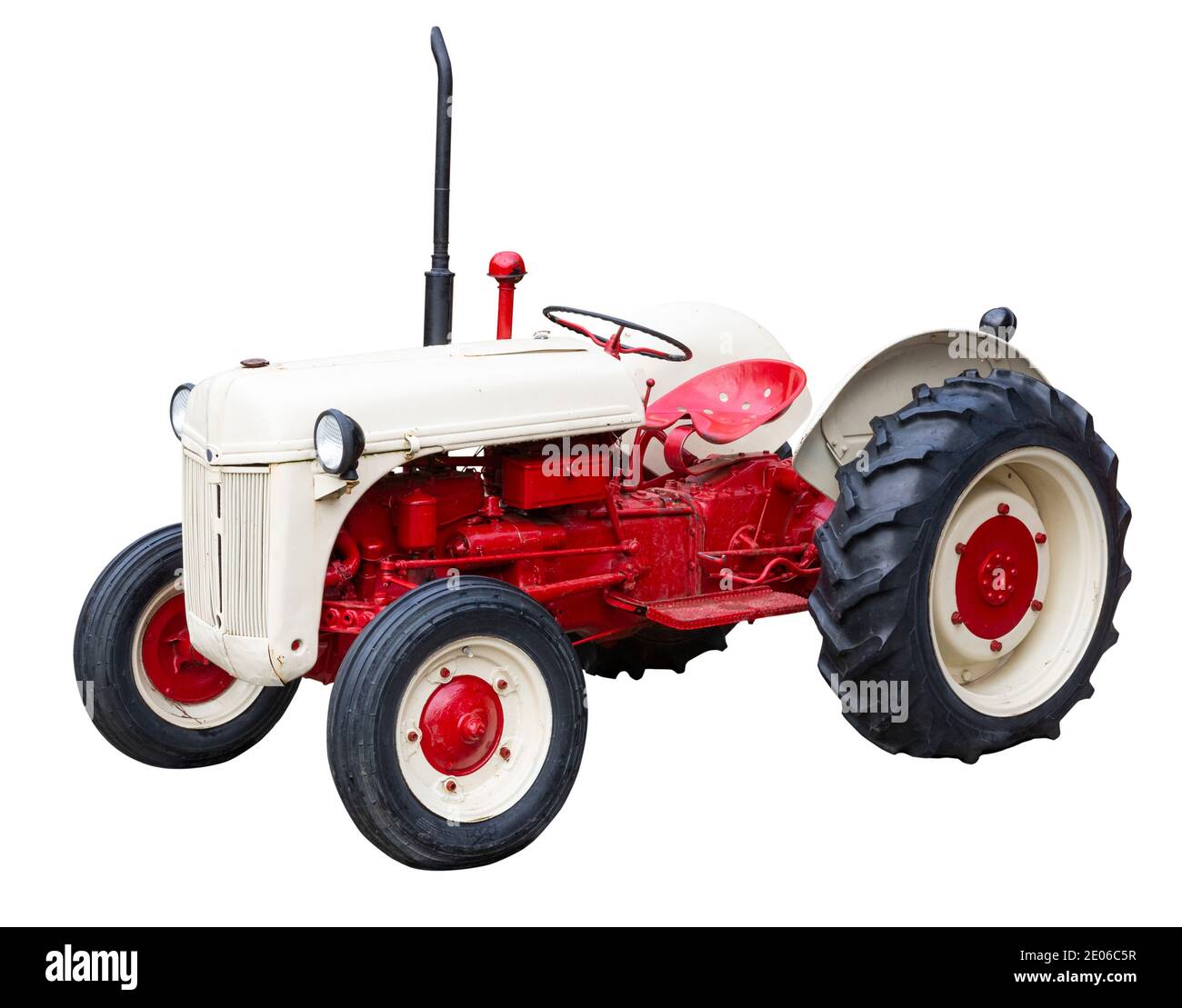 Antique red and cream coloured tractor cut out with a white background Stock Photo