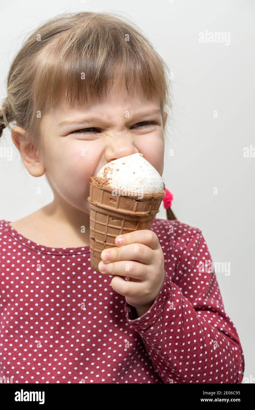 little girl bites off ice cream and has a toothache Stock Photo Alamy