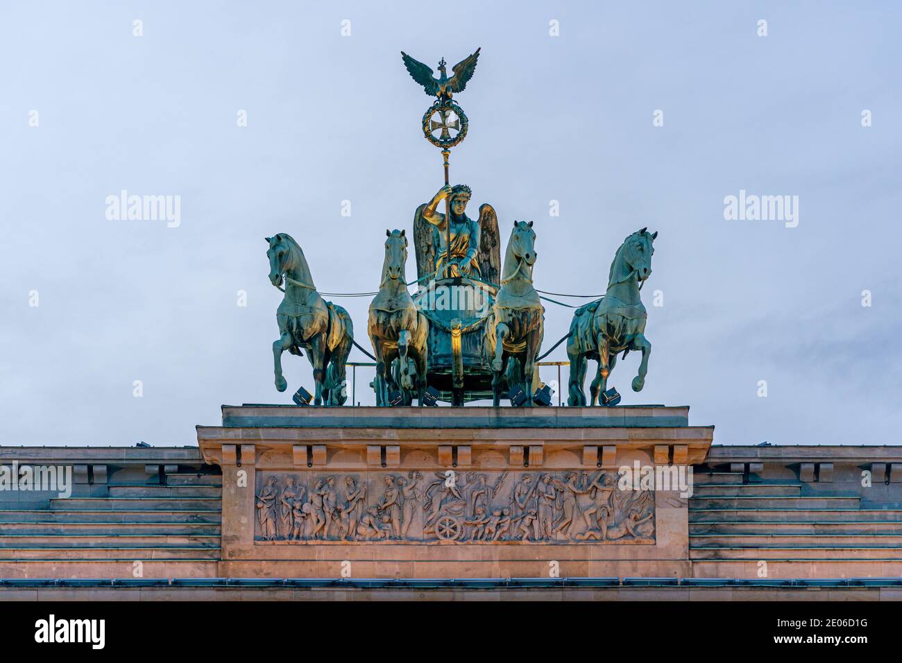 December 28, 2020, Berlin, Detail of the Brandenburg goal on a winter afternoon. The lighting of the Brandenburg goal shines on the quadriga and creates a special lighting atmosphere. The Quadriga by Johann Gottfried Schadow 1793, carried out by the coppersmith Emanuel Jury; Victoria, the goddess of victory, brings peace to the city on a team of four. Below is the sandstone attic relief, designed in 1791 by Bernhard Rode and made by the sculptors Conrad Nicolaus Boy and Christian Unger. | usage worldwide Stock Photo