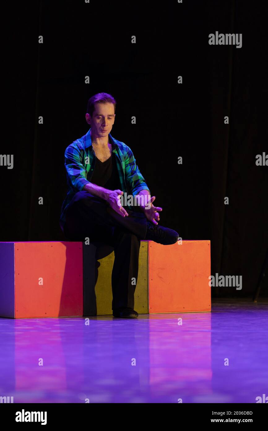 Actor dancer young man performs in the theater on stage in a dance ...