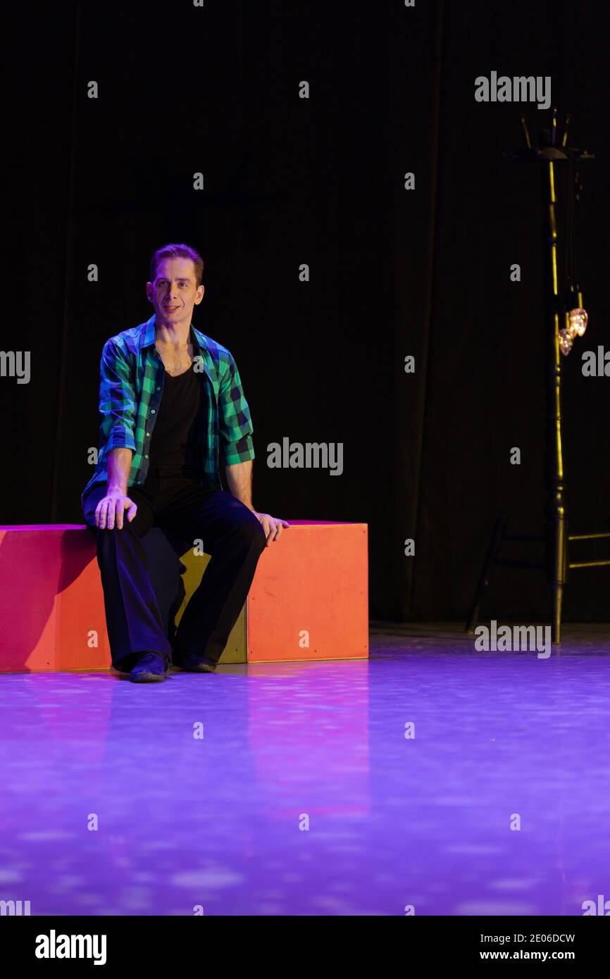 Actor dancer young man performs in the theater on stage in a retro ...