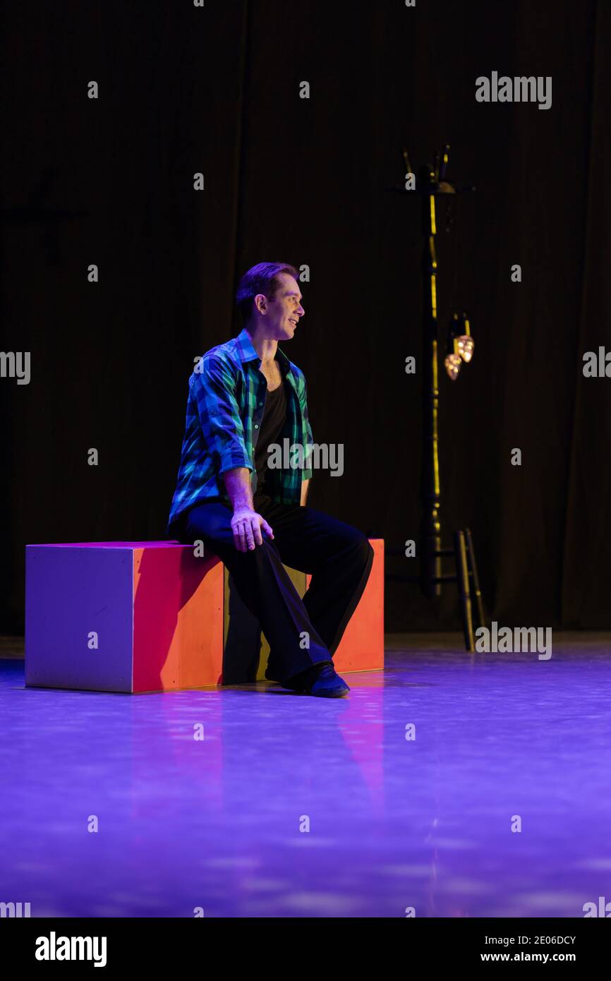 Actor dancer young man performs in the theater on stage in a retro ...