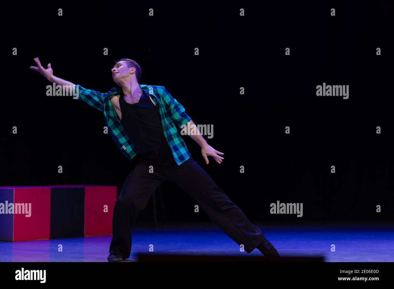 Actor dancer young man performs in the theater on stage in a dance ...