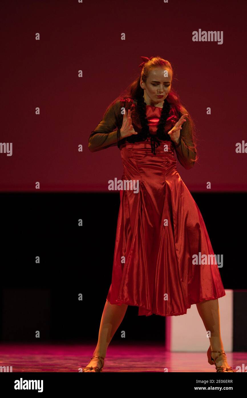 Dancer in a red dress dancing Spanish flamenco on the stage in the ...