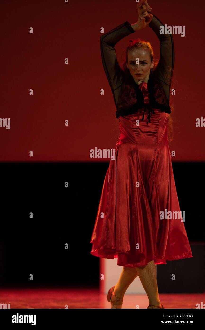 Dancer in a red dress dancing Spanish flamenco on the stage in the ...