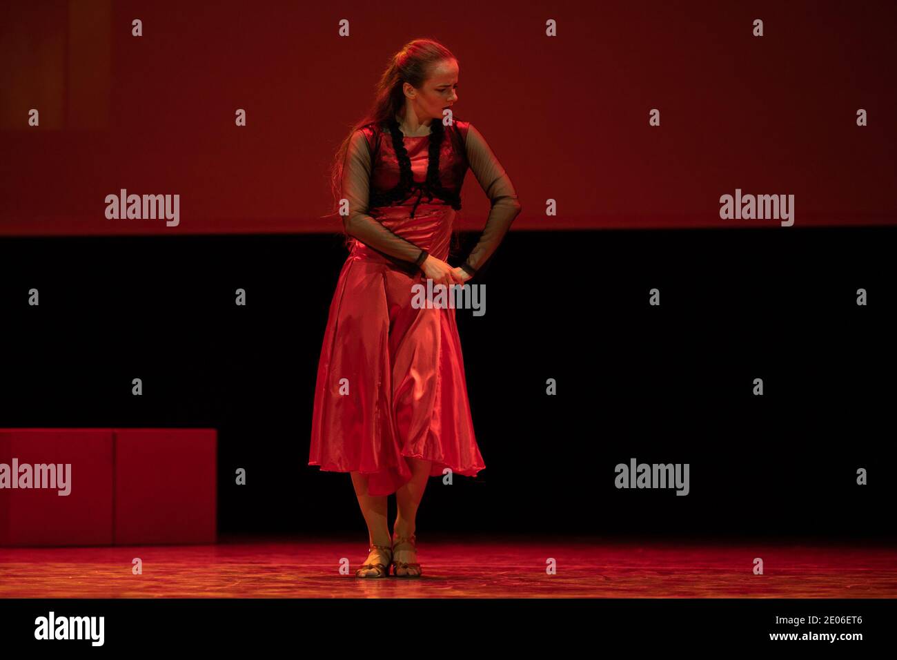 Dancer in a red dress dancing Spanish flamenco on the stage in the ...