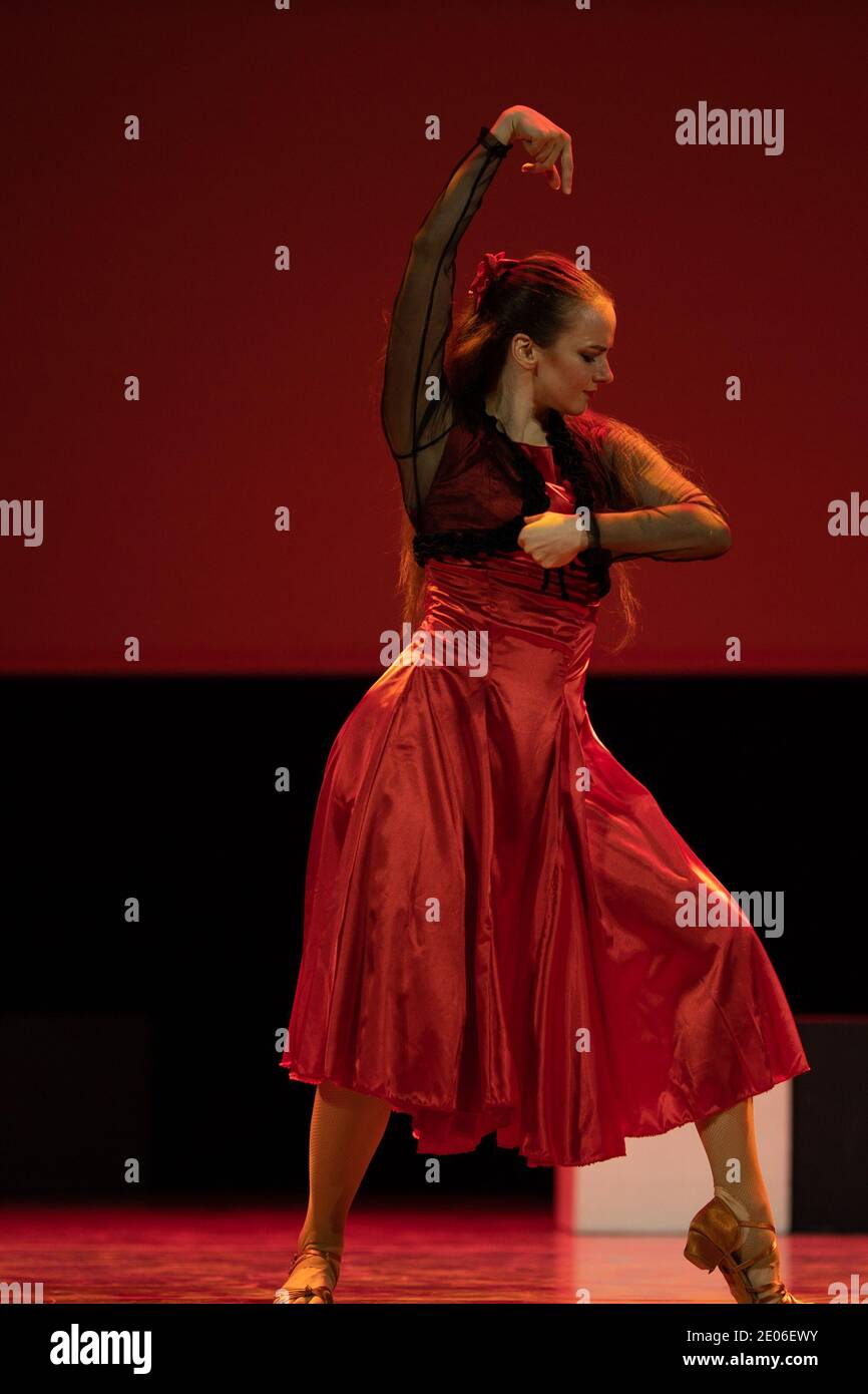 Dancer in a red dress dancing Spanish flamenco on the stage in the ...