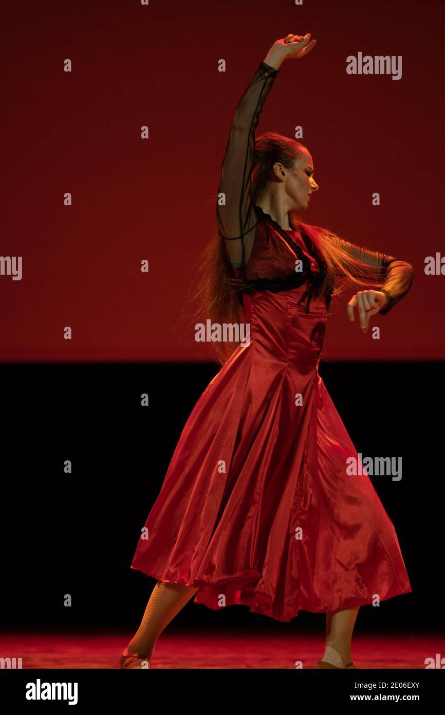 Dancer in a red dress dancing Spanish flamenco on the stage in the ...