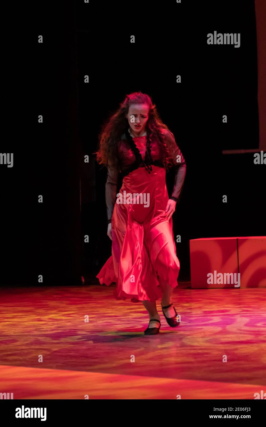 Dancer in a red dress dancing Spanish flamenco on the stage in the ...
