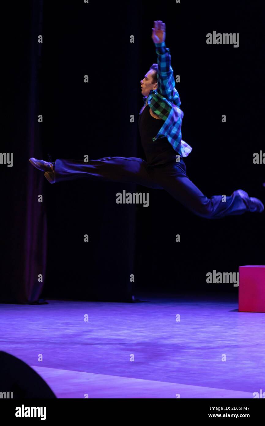 Actor dancer young man performs in the theater on stage in a dance ...