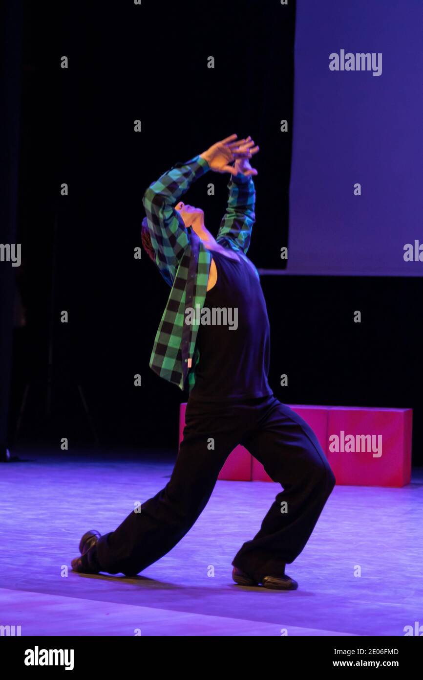 Actor dancer young man performs in the theater on stage in a dance ...