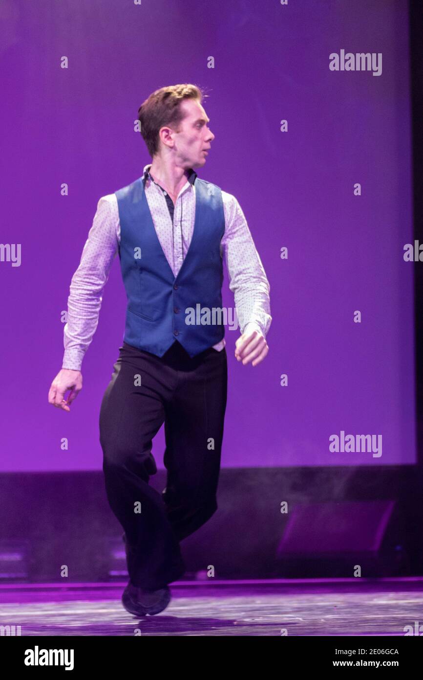 Actor dancer young man performs in the theater on stage in a retro dance musical show Stock Photo