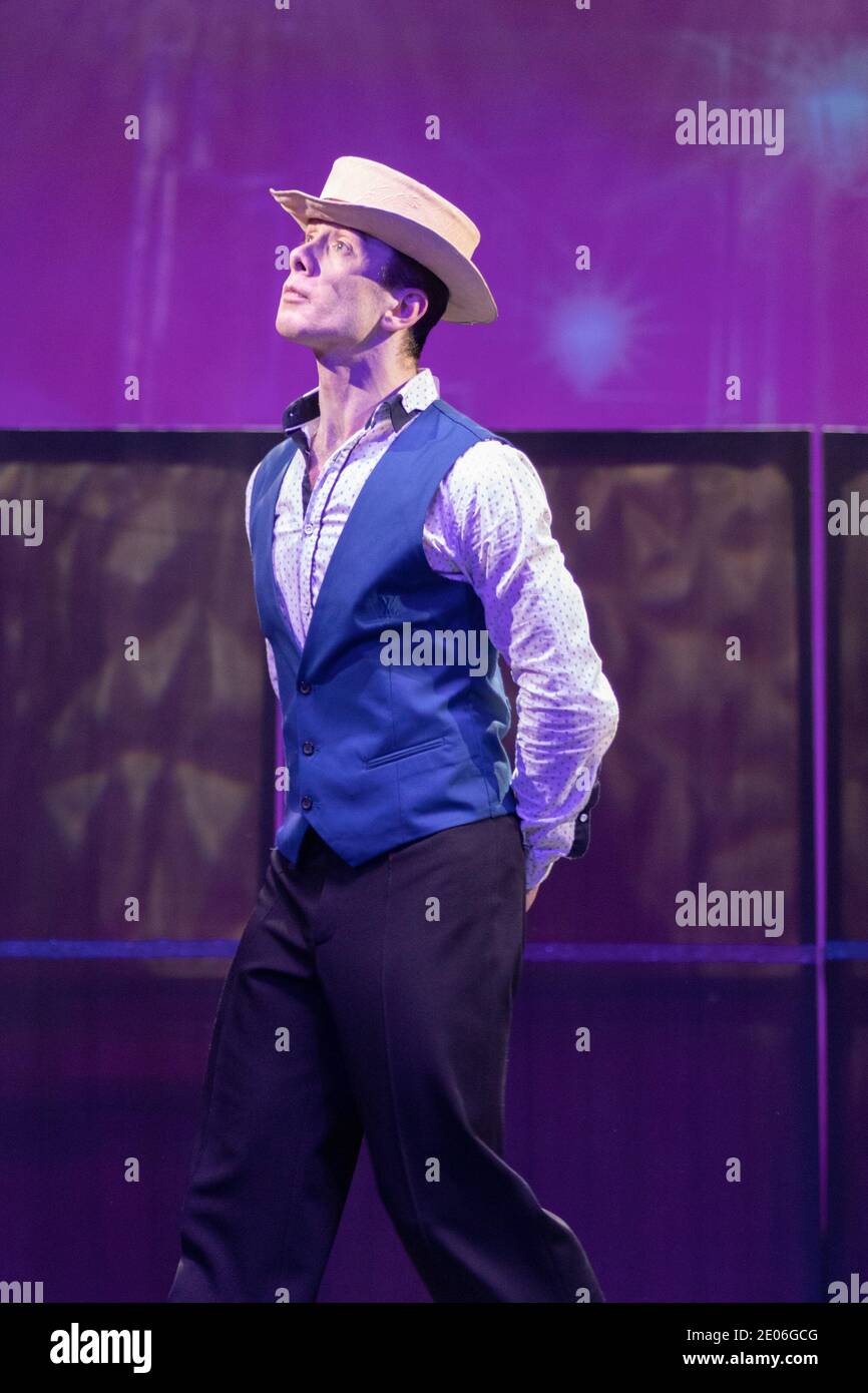 Actor dancer young man performs in the theater on stage in a retro ...