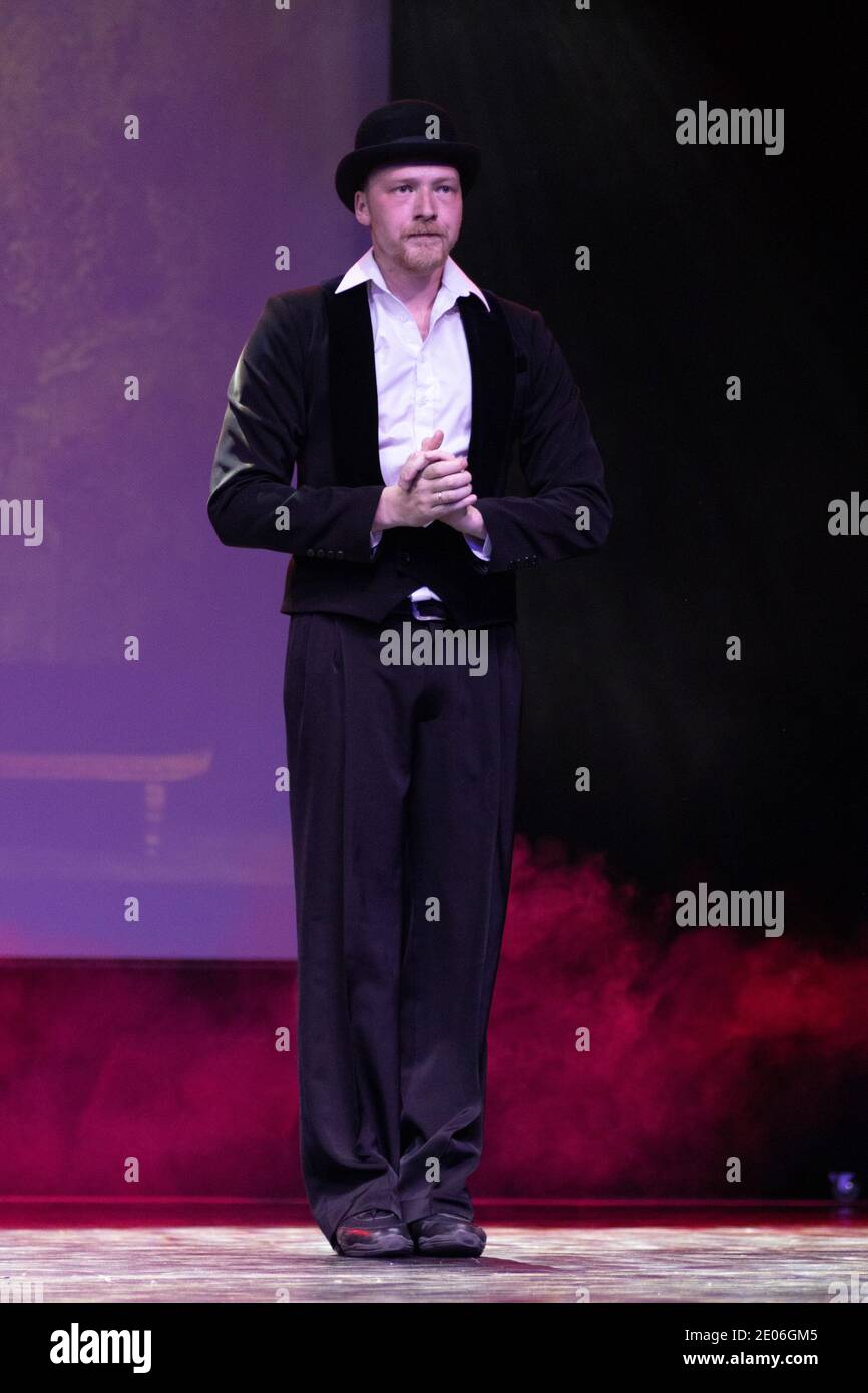 Actor dancer young man performs in the theater on stage in a retro ...