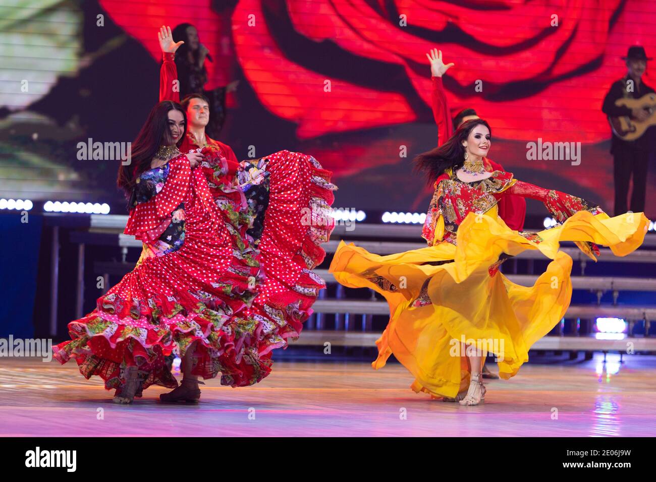 A team of musicians and singers perform on stage in front of the ...