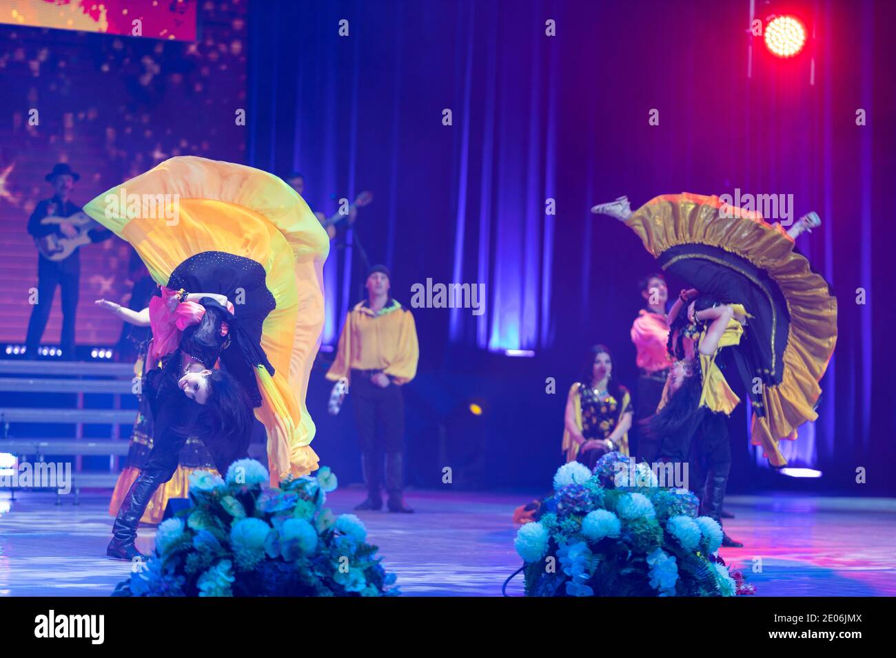 A team of musicians, singers and dancers in gypsy costumes singing and