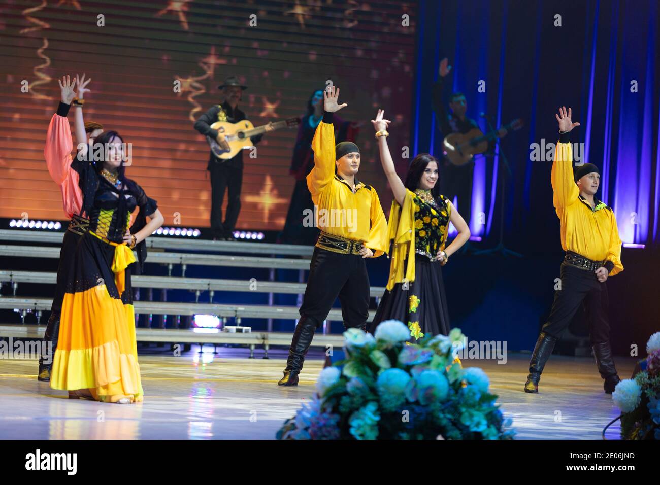 A team of musicians, singers and dancers in gypsy costumes singing and