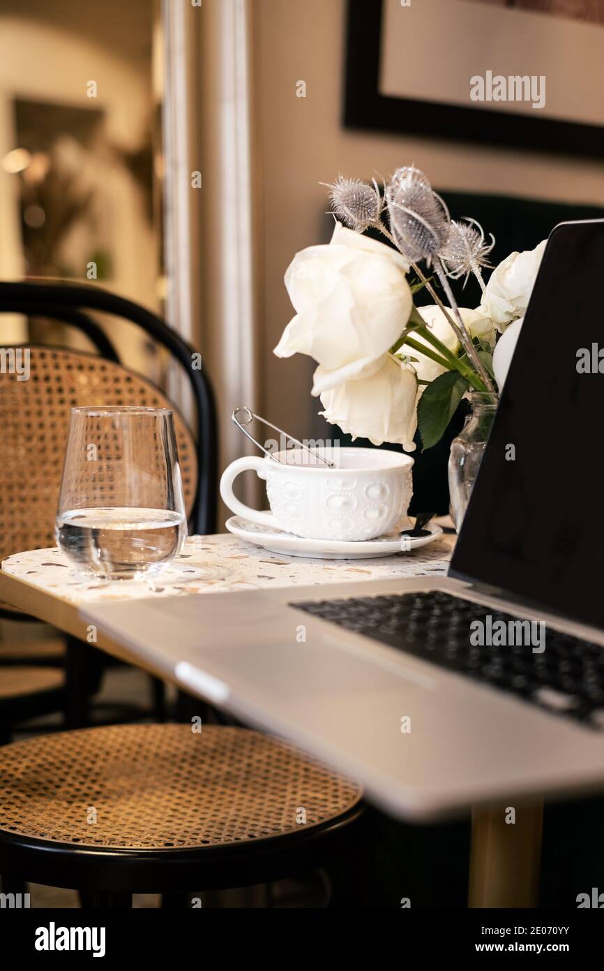 Tea cup laptop in coffee shop vintage effect style pictures Stock Photo