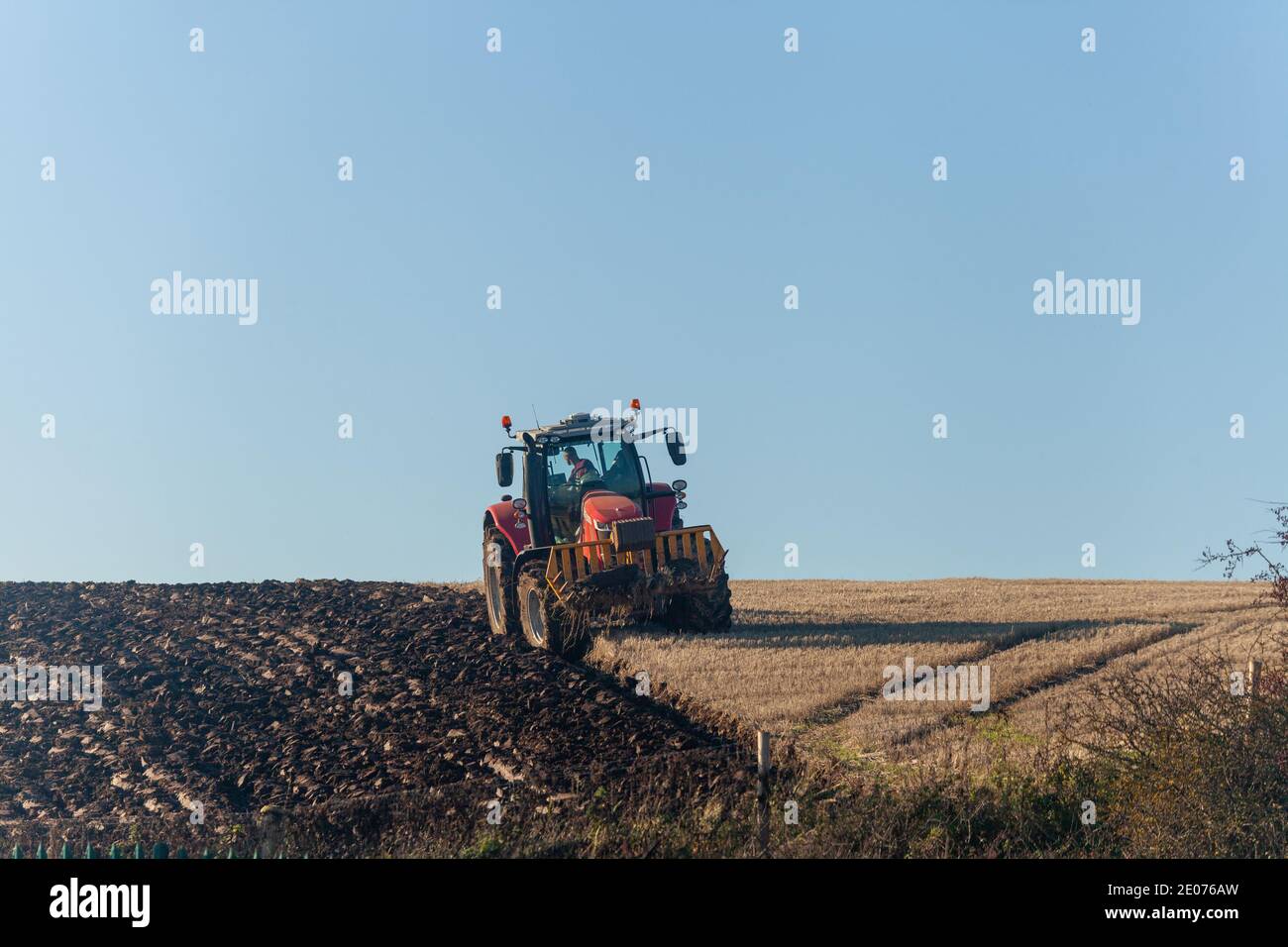 A tractor ploughing a field in November Stock Photo