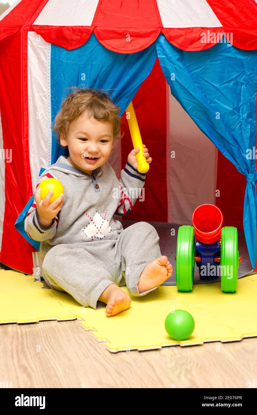 little boy playing with home circus indoors Stock Photo