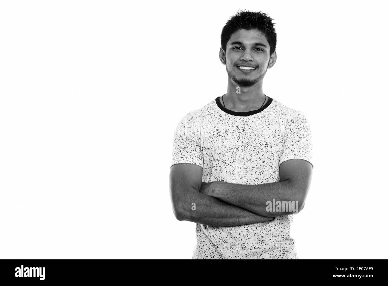 Studio shot of young happy Indian man smiling with arms crossed Stock ...