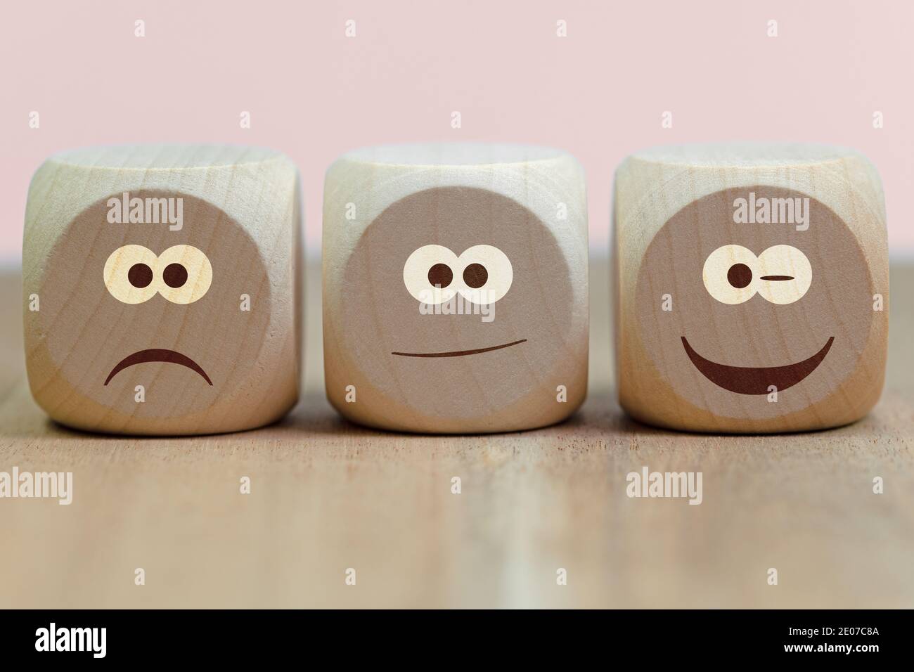 Emoticons with different whims on three wooden cubes Stock Photo