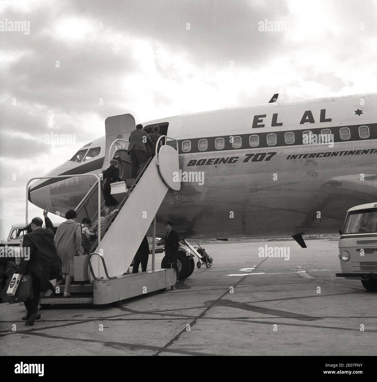 1960s, historical, passengers boarding an EL AL 707 Intercontinental jet aircraft having been dropped on the runway in a Comer van, London Airport, England, UK. Founded in November 1948, as the national airline of Israel, its first flight was from Tel Aviv, Israel to Rome and Paris in 1949. Stock Photo