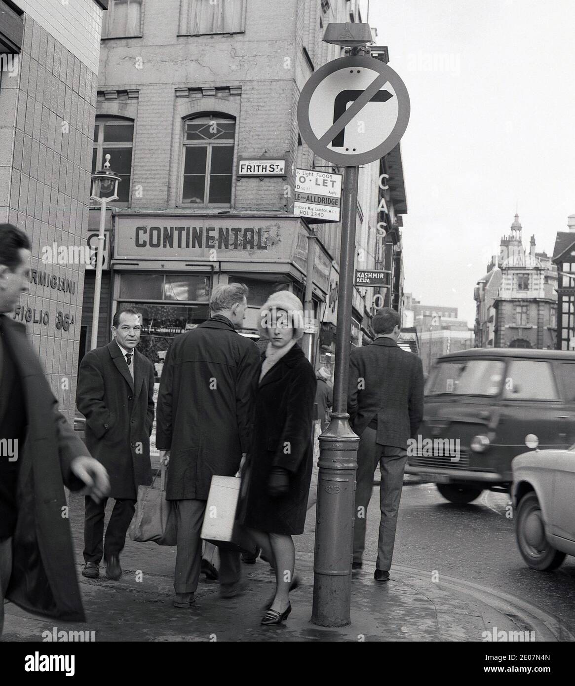 1960s, historical, view of the corner of Frith Street and Old Compton Street, London from this era, showing the fading sign of the 'Continental' stores, passers-by and traffic. In this era, next to the Continental Stores was Angelucci's coffee stores and so Frith St in London's famous Soho area was - and still is - commonly known as 'Little Italy' due to the many Italian cafes and stores along the street. Stock Photo
