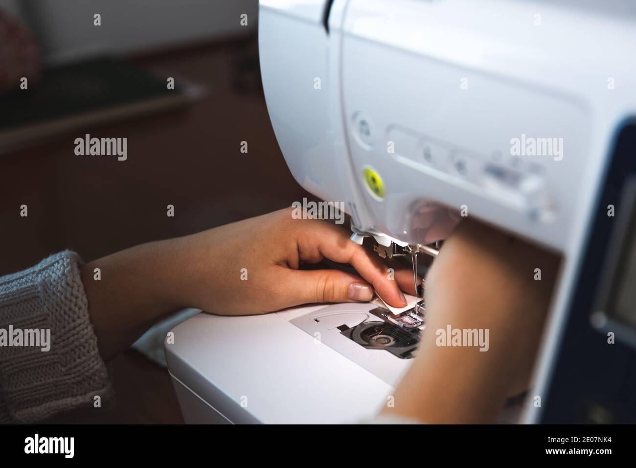 Young woman using a sewing machine Stock Photo - Alamy